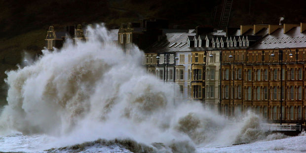 Waves crash against the Aberystwyth coastline, in Wales, as strong winds and high tides continue to blow in from the west. Photo / AP