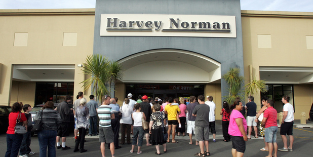 People wait outside of Harvey Norman in Hastings for them to open at 8am on Boxing day. Photo / Glenn Taylor