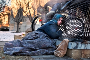 Nick warms himself on a steam grate with three other homeless men just blocks from the Capitol in Washington.