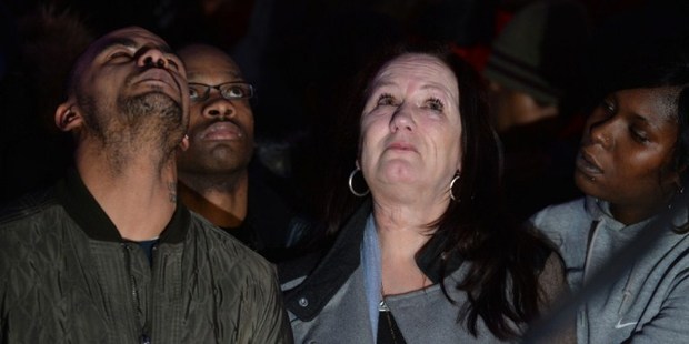 Pam Duggan (C), mother of Mark Duggan, a man shot dead by police in 2011, reacts as relatives address the waiting media. Photo / AP