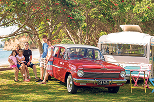 Ashleigh and Andrew Haynes spend their summer holidays with their four children in their two caravans, one of which they tow in their 1963 Holden. Photo / Jason Dorday