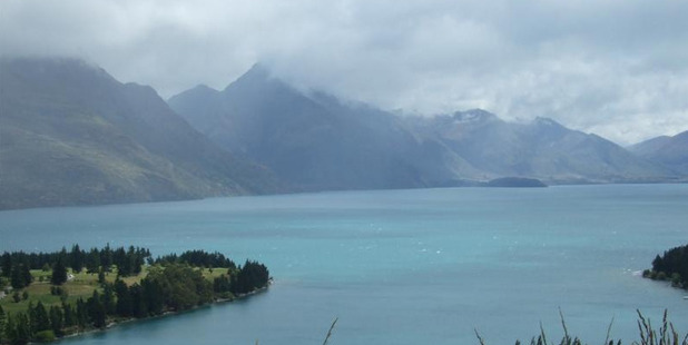 Lake Wakatipu has changed colour following the massive slip at Sandy Bluff, above Chinamans Bluff. Photo / Tracey Roxburgh