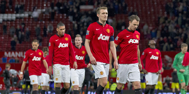 Manchester United players walk from the pitch after their 2-1 loss to Swansea City in their English FA Cup third round. Photo / AP