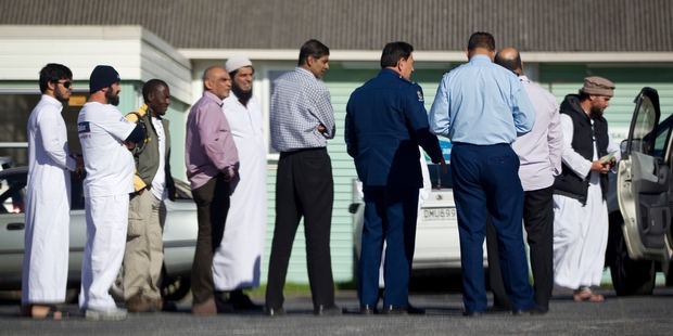 Police speak to witnesses after an incident outside the Avondale Islamic Centre yesterday.