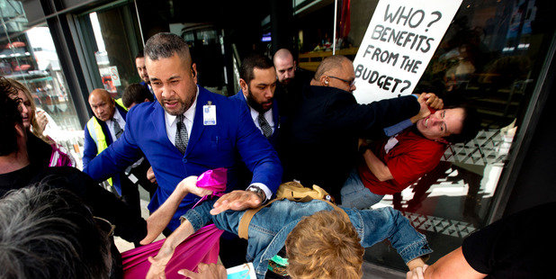 Protesters and SkyCity security clash as they try to storm a lunch at SkyCity hosted by Prime Minister John Key. Photo / Dean Purcell