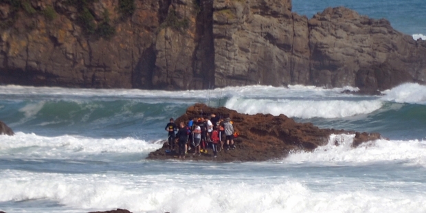 Ten fishermen stranded on a rock in a rising tide near Port Waikato were saved in a daring rescue.