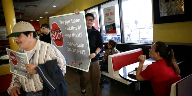 Demonstrators take the protest inside at a McDonald's restaurant in Huntington Park, California, as they press their demands for higher pay and accuse bosses of "wage theft". Photo / AP