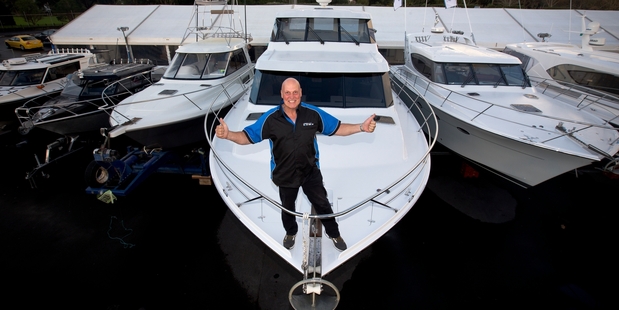 Boat Show general manager Dave Gibbs on the bow of the Maeve, which has shag-pile carpet throughout and sleeps seven comfortably. Photo / Dean Purcell