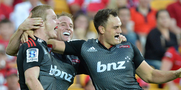 Johnny McNicholl (L) of the Crusaders celebrates with team mates after scoring a try during the round 13 Super Rugby match between the Reds and the Crusaders. Photo / Getty Images.