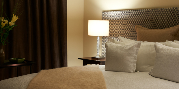 A bedroom at The Dairy Private Luxury Hotel in Queenstown.