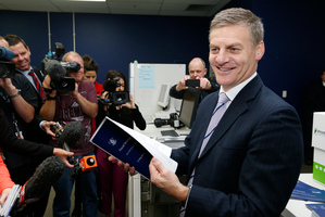 Finance Minister Bill English checking copies of his 2014 Budget as they roll off the press at Printlink in Petone. Photo / Mark Mitchell
