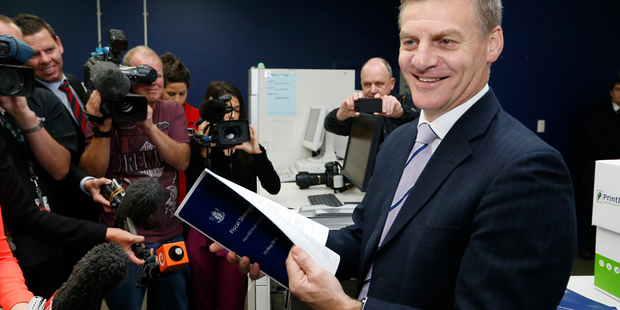 Finance Minister Bill English checking copies of his 2014 Budget as they roll off the press earlier this week. Photo / Mark Mitchell