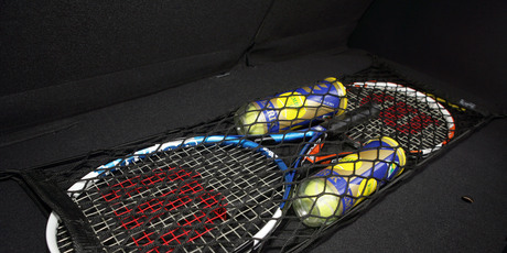 Sports gear stored securely in a cargo net .