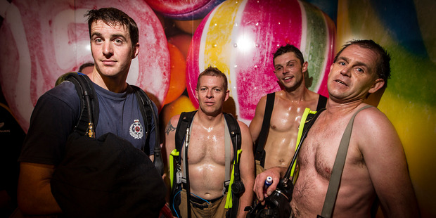 Firefighter Sky Tower Stair Challenge 2014. Firefighters Alistair Leitch, Glen Thurston, Jimmy Connoloy and Mark Hutton catch the lift down after finishing. Photo / Michael Craig