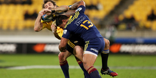 WELLINGTON, NEW ZEALAND - MAY 16: Conrad Smith of the Hurricanes is tackled by Malakai Fekitoa of the Highlanders during the round 14 Super Rugby match between the Hurricanes and the Highlanders at W