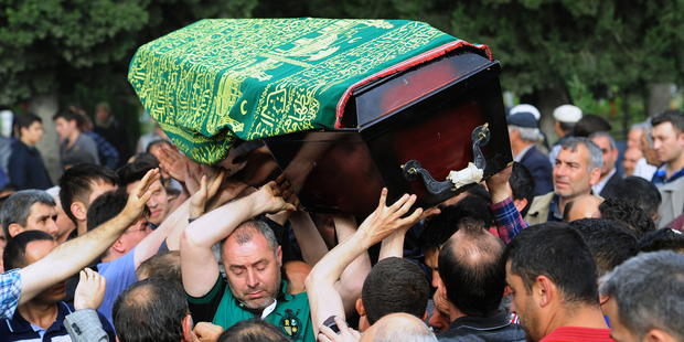 People bear a coffin aloft, of one mine accident victim for burial in Soma, Turkey. Photo / AP