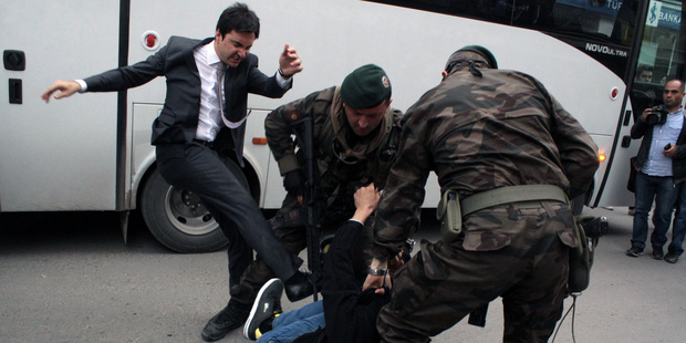 A person identified by Turkish media as Yusuf Yerkel, advisor to Turkish Prime Minister Recep Tayyip Erdogan, kicks a protester already held by special forces. Photos / AP