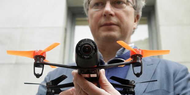 Parrot CEO Henri Seydoux holds a Parrot Bebop drone. The drone, which has a 14-megapixel camera and battery life of 12 minutes flying time, is scheduled to be released later this year. Photo / AP