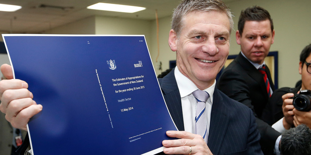 Finance Minister Bill English checking copies of his 2014 Budget as they roll off the press. Photo / Mark Mitchell