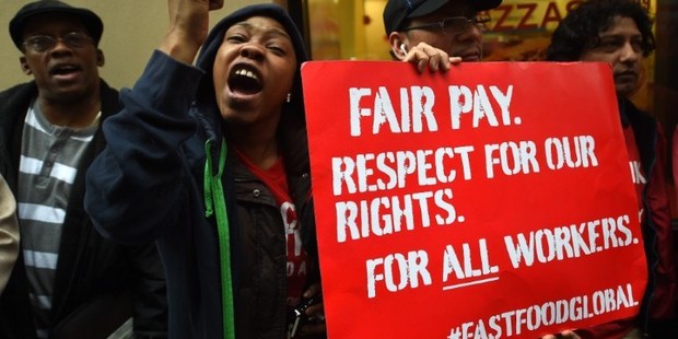 Fast-food workers around the world this month staged a global protest to demand an increase of their minimum wage. Photo / AFP