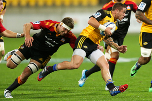 TJ Perenara of the Hurricanes is tackled by Michael Fitzgerald of the Chiefs during the round 15 Super Rugby match between the Hurricanes and the Chiefs. Photo / Getty Images.