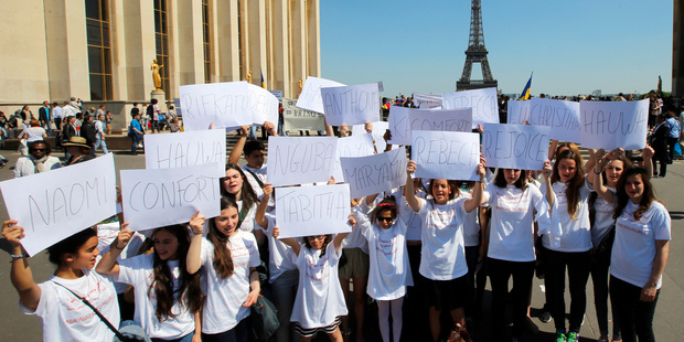 Young French demonstrators hold up papers with the names symbolizing the abducted girls in Nigeria during a demonstration at Trocadero, in Paris. Photo / AP