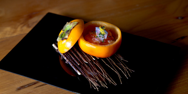 Salmon served in a scooped-out persimmon shell at Cocoro. Photo / Dean Purcell
