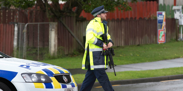 Police at the scene of the Luanda Drive shooting in Ranui where one man was killed and another critically injured. Photo / Brett Phibbs