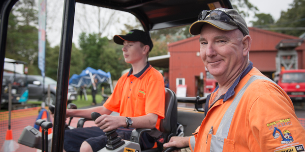 Logan Collings, left, shows Alistair McIntyre evidence of his passion for a career in earthmoving. Photo / Ted Baghurst