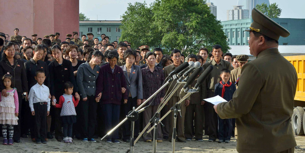 A North Korean official, right, apologises in front of families of victims of an accident at an apartment construction in Pyongyang. Photo / AP