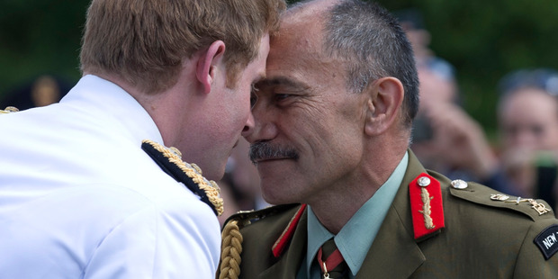 Britain's Prince Harry, receives a hongi, from Governor-General Sir Jerry Mateparae, as he arrives at the New Zealand War Cemetery. Photo / AP