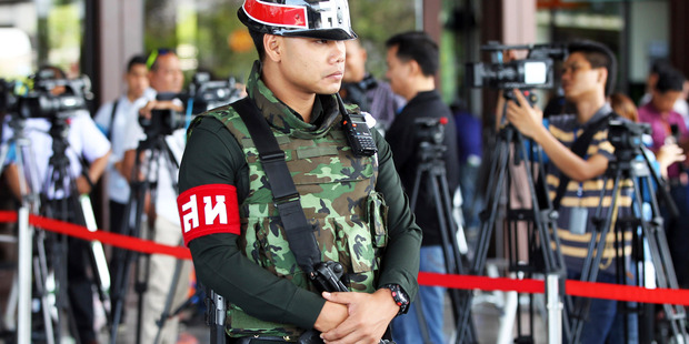 An armed Thai military police stands guard at the entrance to a hall of the army club prior to a meeting between Thai Armed Forces Chiefs and high ranking officials. Photo / AP