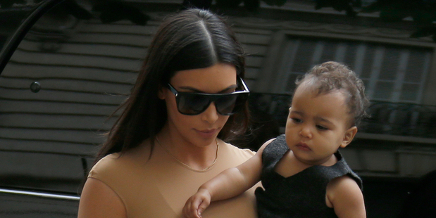 Kim Kardashian carries her daughter North West as she arrives at a luxury shop in Paris this week.
Photo / AP