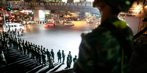 Thai soldiers secure the intersection to prevent pro-government protesters to gather to protest against the coup in downtown Bangkok. Photo / AP