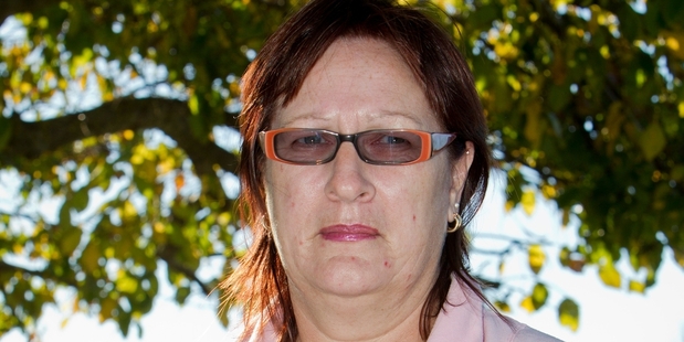 Tui Allan with photos of her pit bull dog that has been stolen from the Hastings pound. Photo/Glenn Taylor