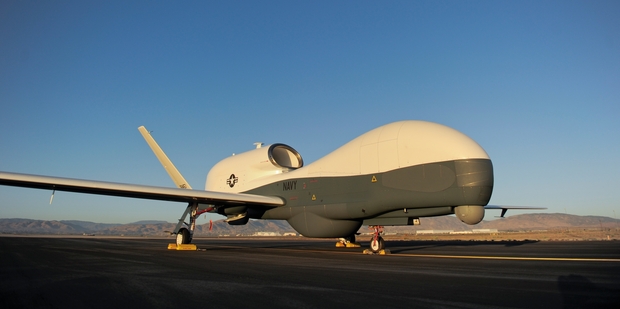 An RQ-4 Global Hawk unmanned aerial vehicle sits on a flight line.