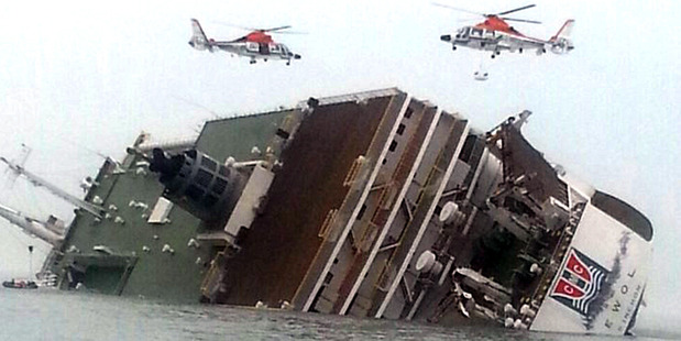 South Korean rescue helicopters fly over a South Korean passenger ship, trying to rescue passengers from the ship in water off the south coast. Photo / AP