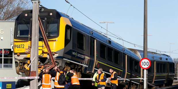 The Metlink Matangi train is inspecting by Transrail staff after crashing over a barrier at the Melling Station in Lower Hutt. Photo / Mark Mitchell