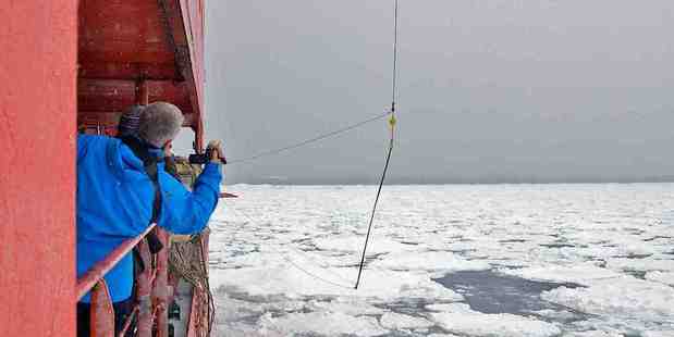 A buoy to measure waves is lowered on to sea ice. Photo / Rob Johnson