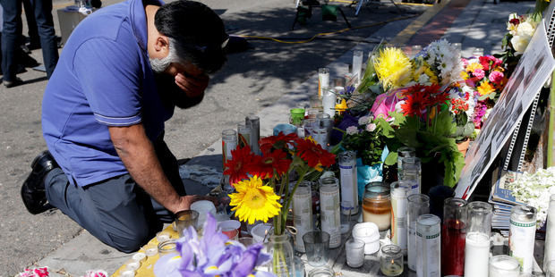 A man pays his respects at a makeshift memorial in the Isla Vista area near Goleta, California. Photo / AP