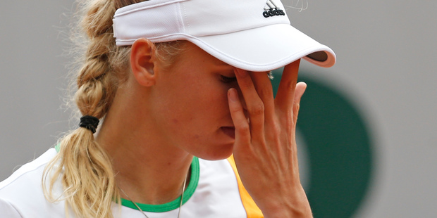 Denmark's Caroline Wozniacki wipes her face during the first round match of the French Open tennis tournament. Photo / AP