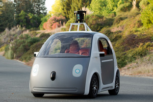 Members of the public try a protoype of Google's self-driving two-seater car, which will have no controls other than a stop-go button. Photo / AP