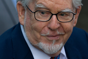 Veteran entertainer Rolf Harris arrives at Southwark Crown Court in London. The artist has been sketching in court - but that's been dealt to by the judge. Photo / AP