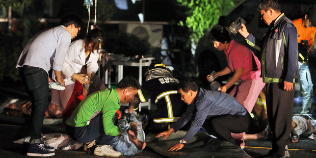 Rescue workers treat victims of a major fire at a hospital in Jangseong, South Korea. Photo / AP