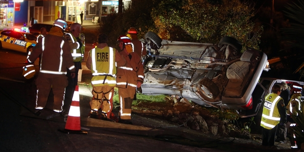 DANGEROUS WORK: Emergency services work to free a woman trapped in her car.PHOTO/JOHN STONE