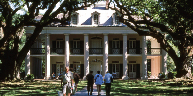 Visitors to the Oak Alley Plantation walk through the dappled shade of the avenue to the main house at Vacherie, in Louisiana. Photo / Paul Rush