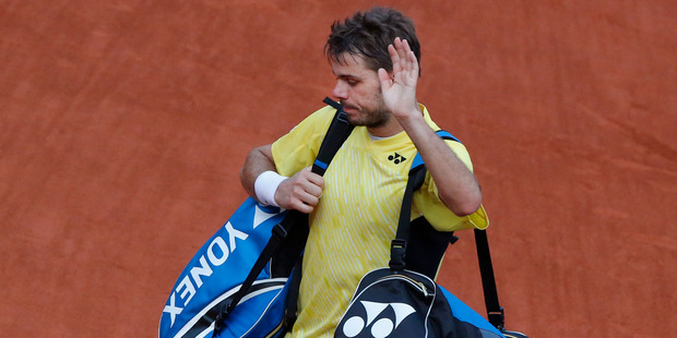 Switzerland's Stanislas Wawrinka waves goodbye to spectators after losing the first round match of the French Open. Photo / AP