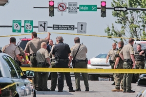 Officers outside the Georgia courthouse where heavily armed gunman Dennis Marx was shot dead in June. Photo / AP