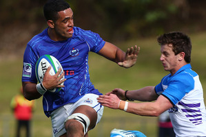Giovanni Habel Kueffner of Samoa fends off the tackle of Alex Glashan of Scotland. Photo / Getty Images