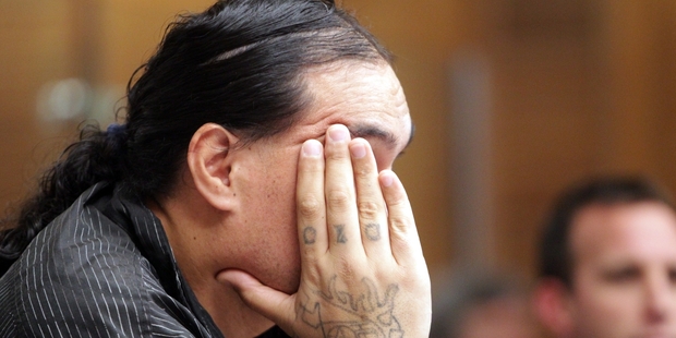 Murder accused Steven Tiwini Rakuraku tries to hide his face from cameras before he represented himself in court yesterday.